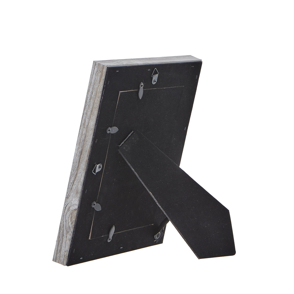 Rear view of the photo frame with its black folding easel extended, retaining tabs around the backing and hanging loops visible.