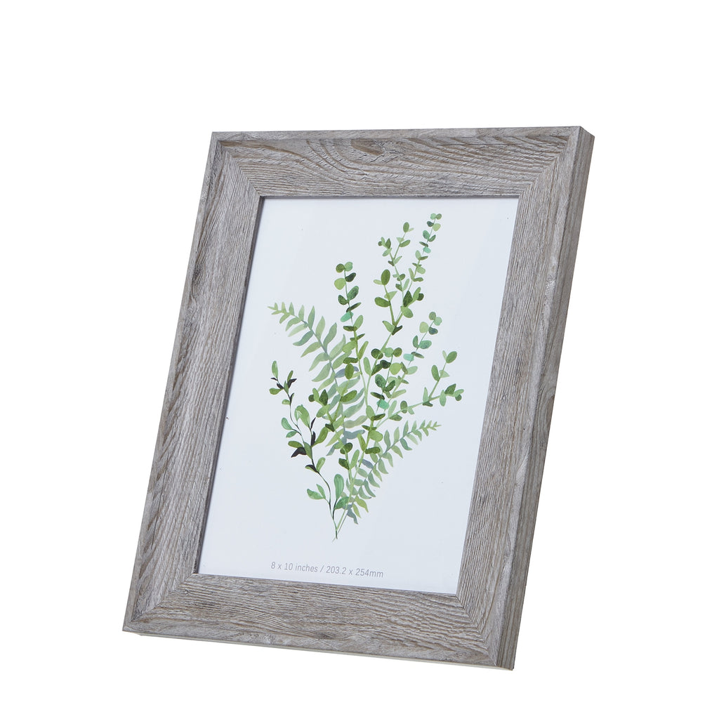 Angled front view of a portrait photo frame with a broad pale grey-brown woodgrain-look border and green botanical insert.