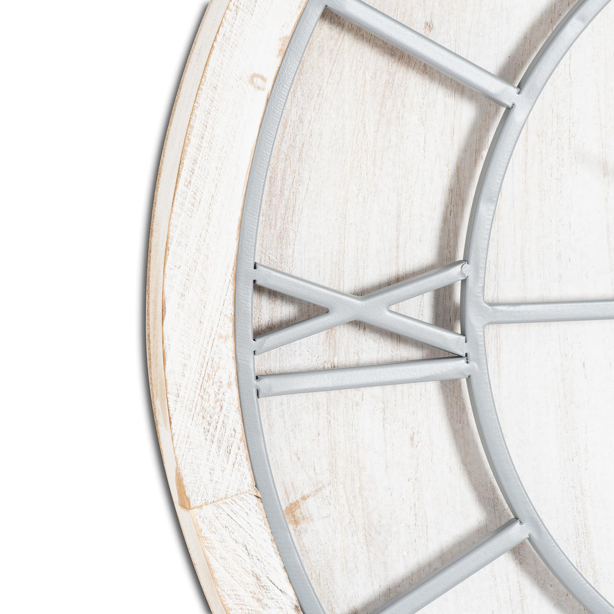 Close-up of the clock's light-grey Roman numeral IX and curved framework against the distressed whitewashed face and rim.