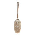 Full view of a pale washed pinecone-shaped ornament with overlapping scales and a long knotted rope hanging loop on a white background.