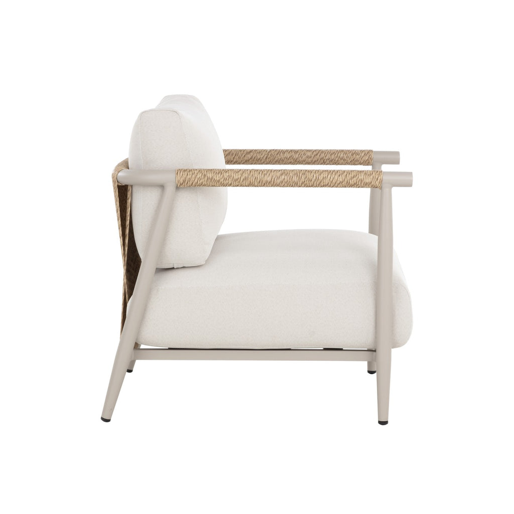 Side view showing the lounge chair's reclined back, faux-rattan detailing, thick cream seat cushion and angled rear leg.