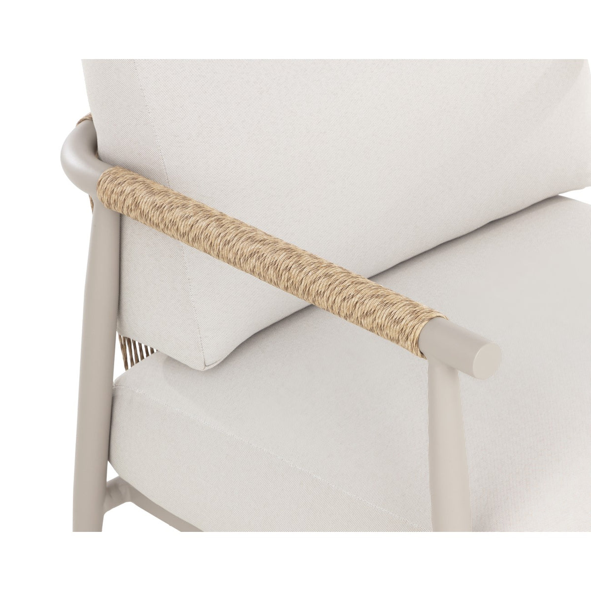 Close-up of the tan wrapping along an armrest, its rounded greige end and the fine weave of the cream cushions.