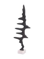 Angled view of the Waveform Sculpture showing its textured dark surface, warm edge highlights and marble plinth.