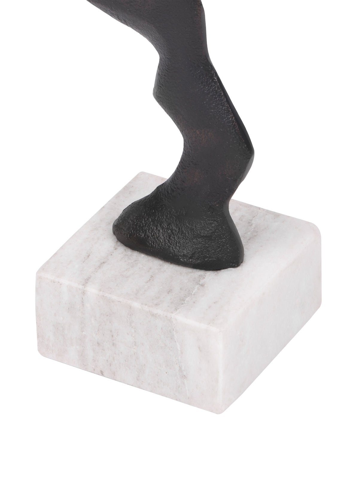 Close-up of the sculpture's curved lower stem meeting a pale marble block base with subtle veining.