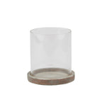 Candle lantern with a clear open cylindrical sleeve seated in a shallow mottled brown and grey base, shown against white.