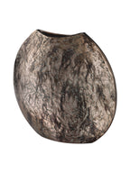 Angled view of the weathered vase showing its curved body, narrow side and elongated dark opening.