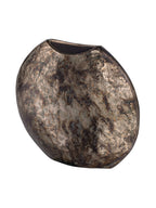 Angled view of the curved vase showing its narrow side, dark interior and mottled metallic surface.