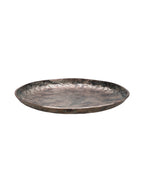 Low angled view showing the platter's shallow profile and bronze outer edge with green patina detailing.