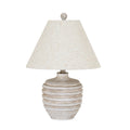 Table lamp on a white background with a weathered cream and grey banded body, sloping shoulders, wide tapered cream shade and rounded finial.