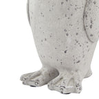 Close-up of the penguin ornament's lower body and wide webbed feet, showing raised toe details and grey flecks over the off-white finish.