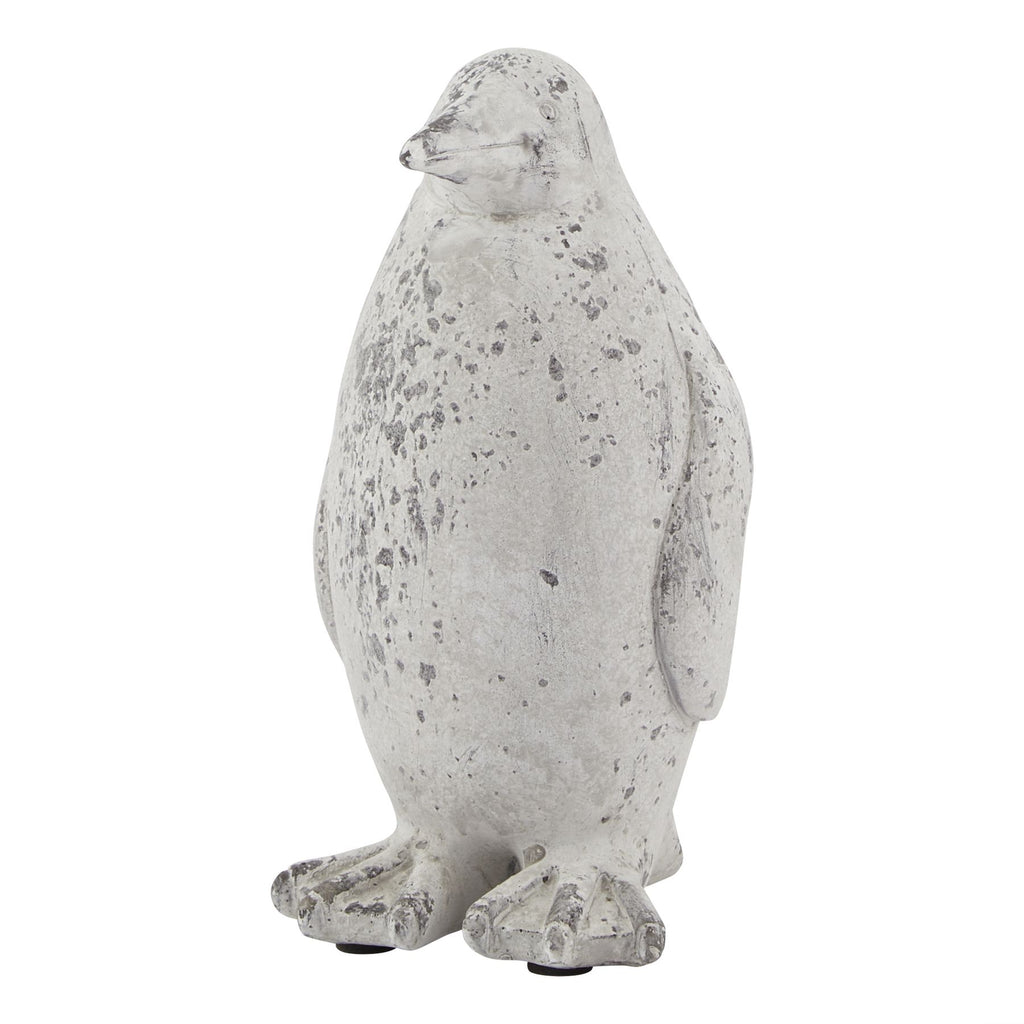 Upright penguin ornament viewed at a slight angle, showing its rounded body, outlined wing and broad webbed feet in mottled off-white and grey.