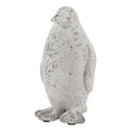 Upright penguin ornament viewed at a slight angle, showing its rounded body, outlined wing and broad webbed feet in mottled off-white and grey.