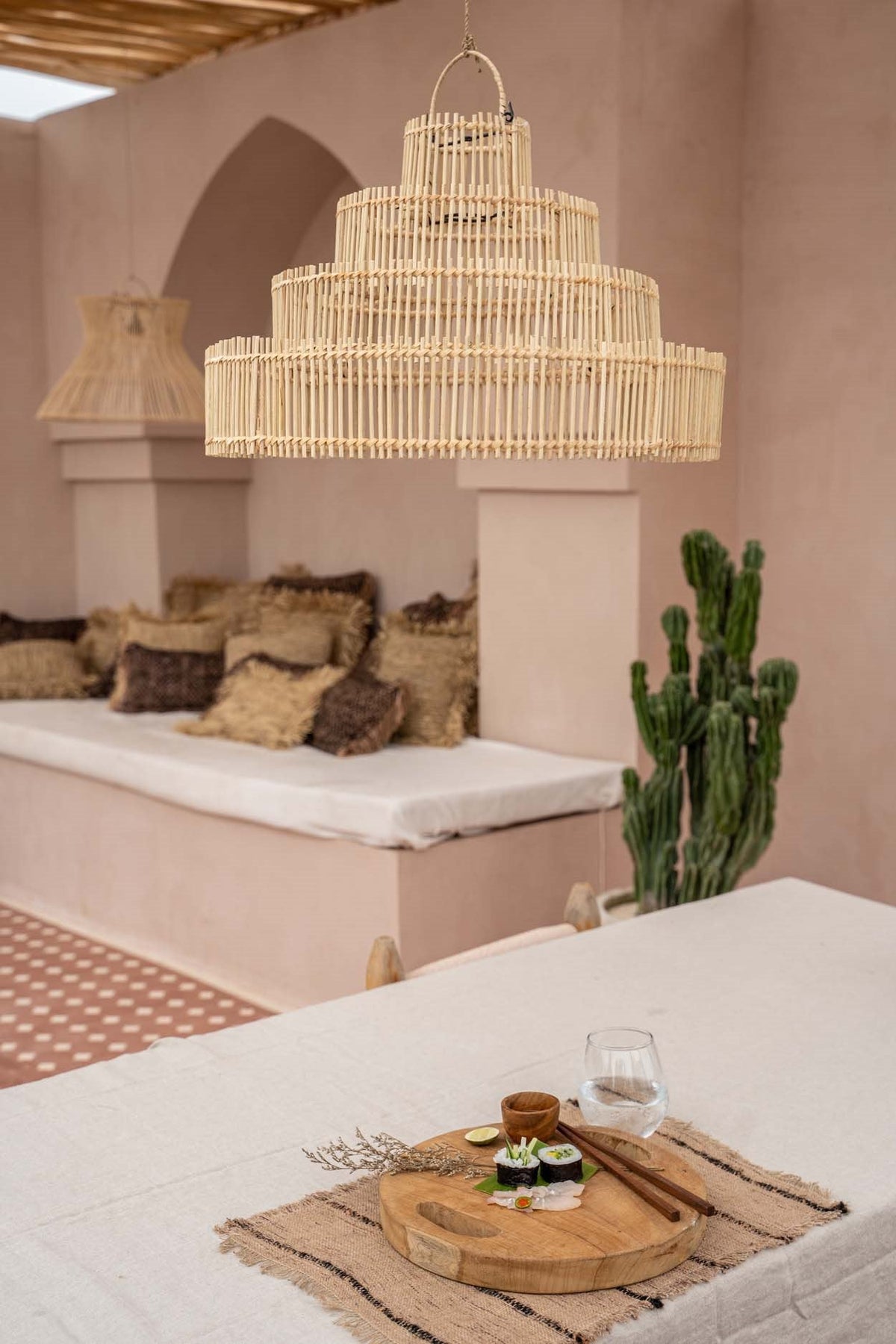 Wedding Cake Rattan Pendant Light – Natural, Medium — styled above a dining table