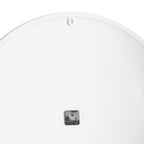 Rear view of the clock showing a plain white circular back, a small dark movement and a keyhole-cut hanging tab at the top.