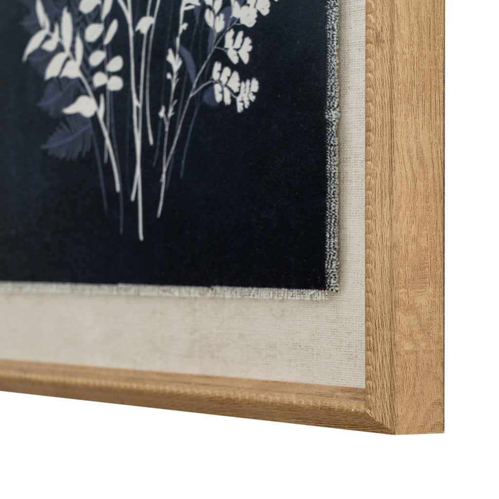 Angled close-up of the artwork's lower right corner, showing fine texture around the dark print, the pale surround and the grain-like tan-gold frame finish.