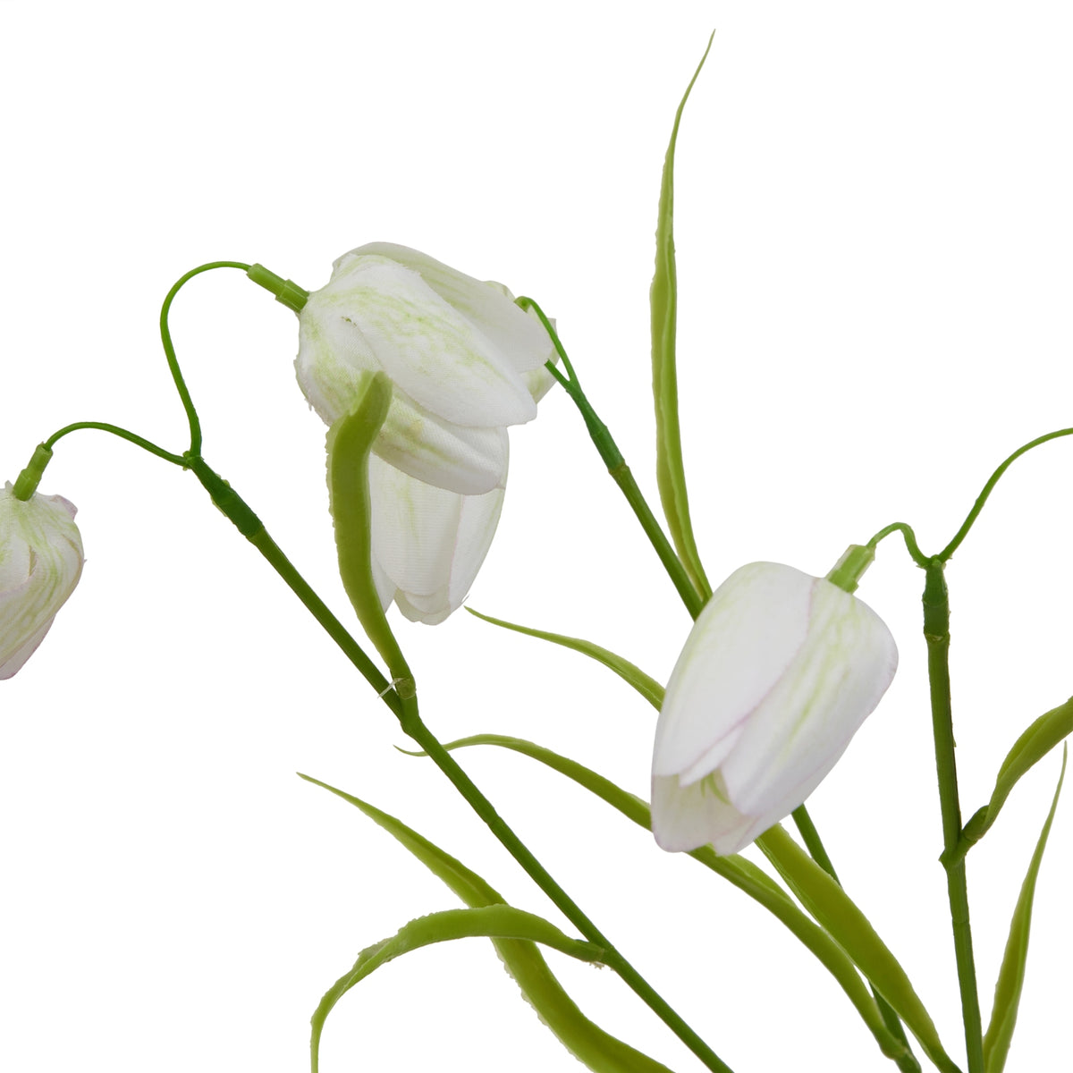 Close-up of white bell-shaped artificial flowers with faint green markings, overlapping petals and curved green stalks among pointed leaves.