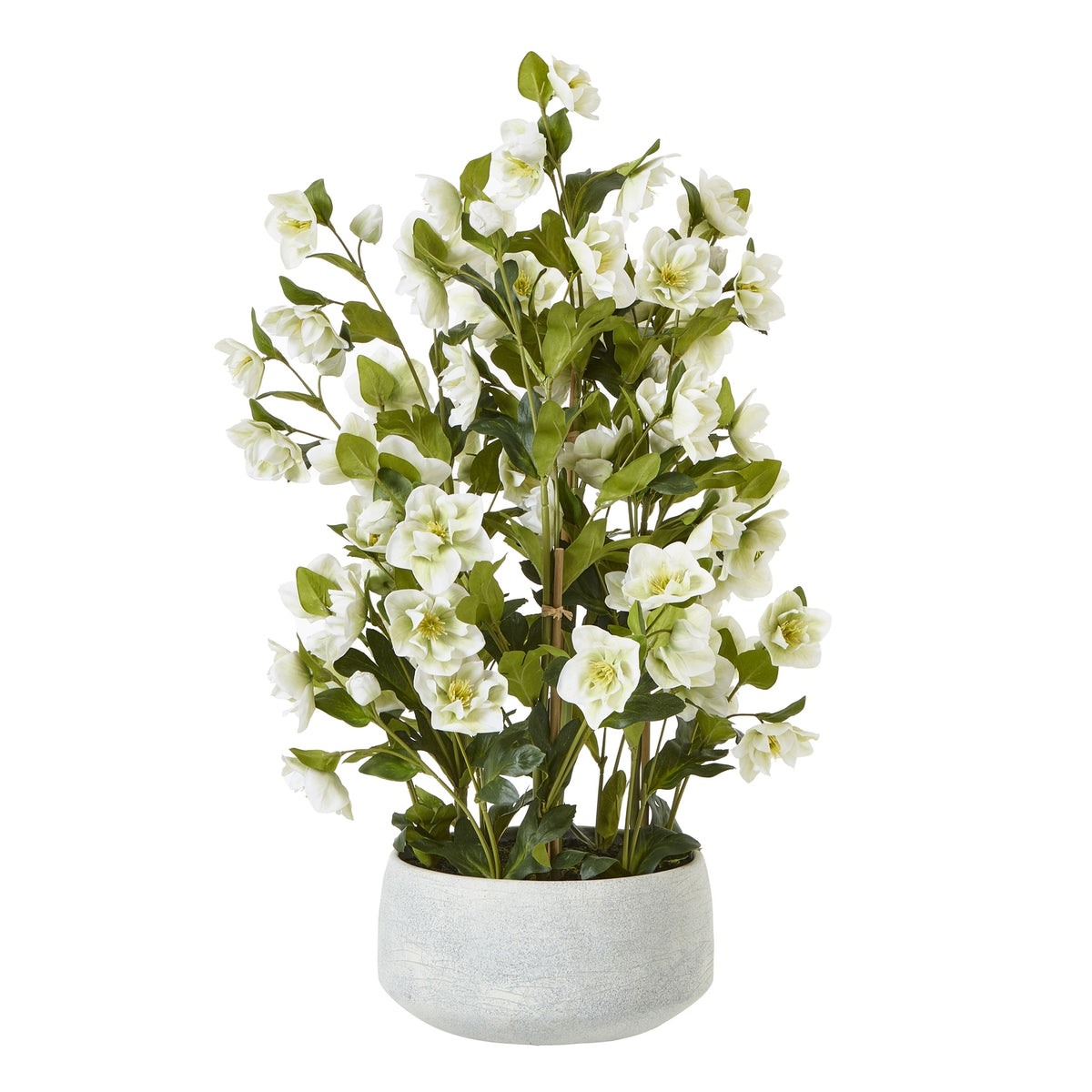 Full view of a branching artificial white flower arrangement with green foliage in a low rounded pale grey pot.