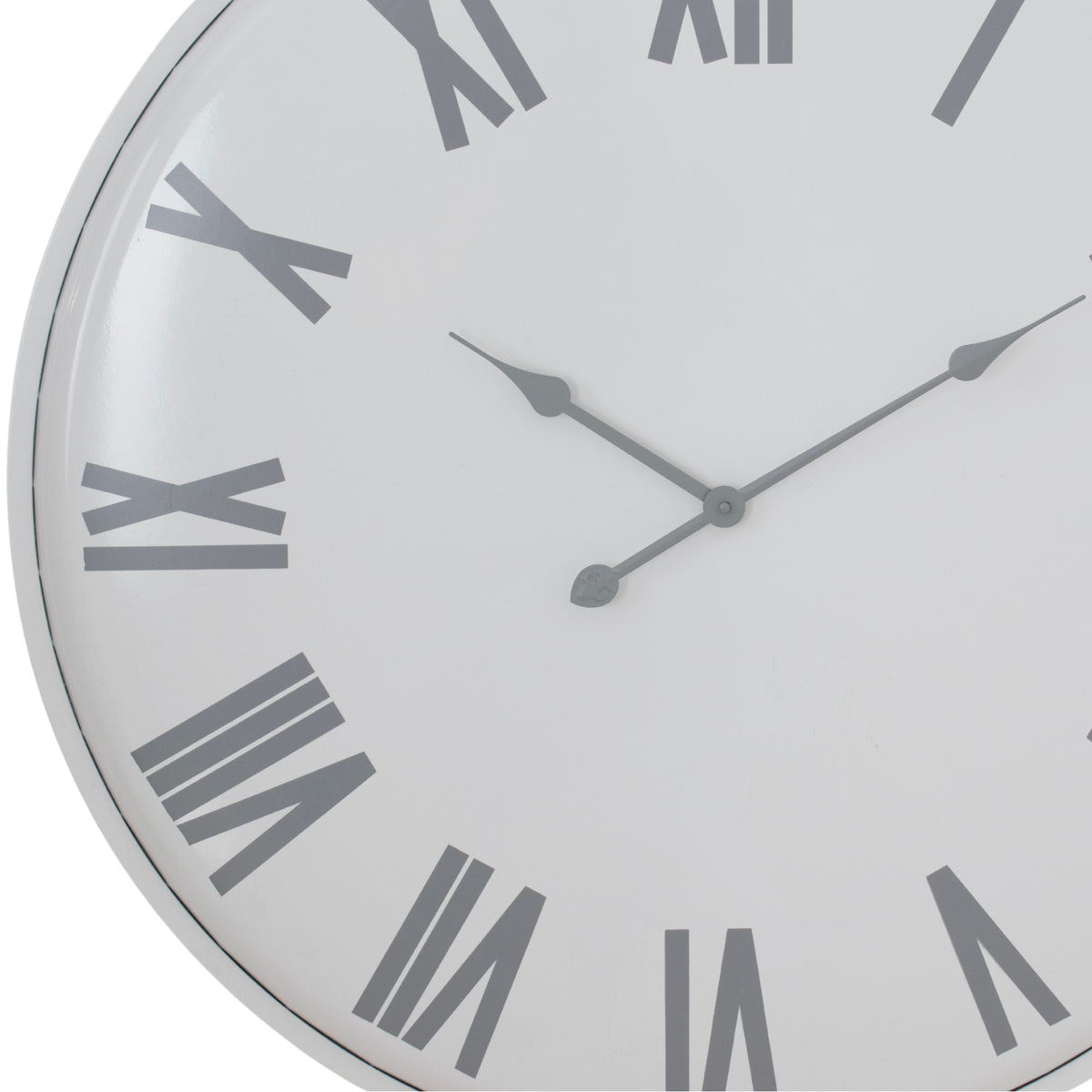 Close-up of the white clock dial showing the shaped grey hands, bold Roman numerals and narrow outer rim.