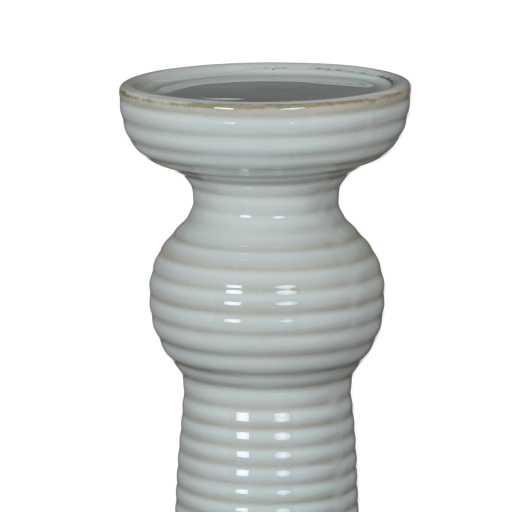 Close-up of the candle holder's broad cup and rounded upper collar, showing horizontal ribs and a faint beige line around the rim.
