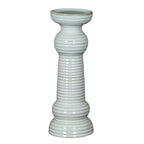 Full view of a glossy white pillar candle holder with a broad circular cup, ribbed column, rounded collars and tiered flared foot.