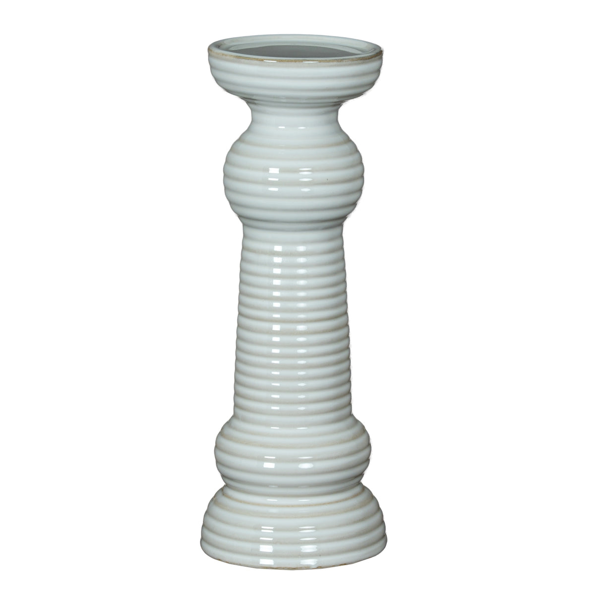 Full view of a glossy white pillar candle holder with a broad circular cup, ribbed column, rounded collars and tiered flared foot.