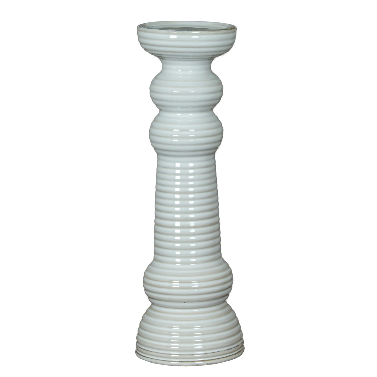 White pillar candle holder shown in full, with a circular cup, two rounded collars, a long ribbed column and a flared tiered foot.