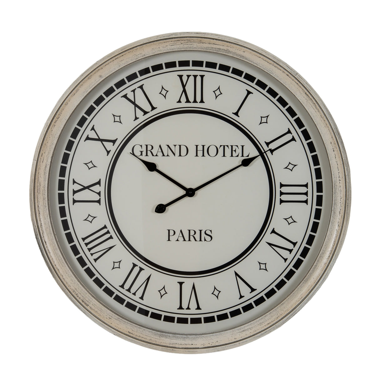 Front view of a round wall clock with a distressed white frame, pale face, black Roman numerals and hands, and Grand Hotel Paris lettering.