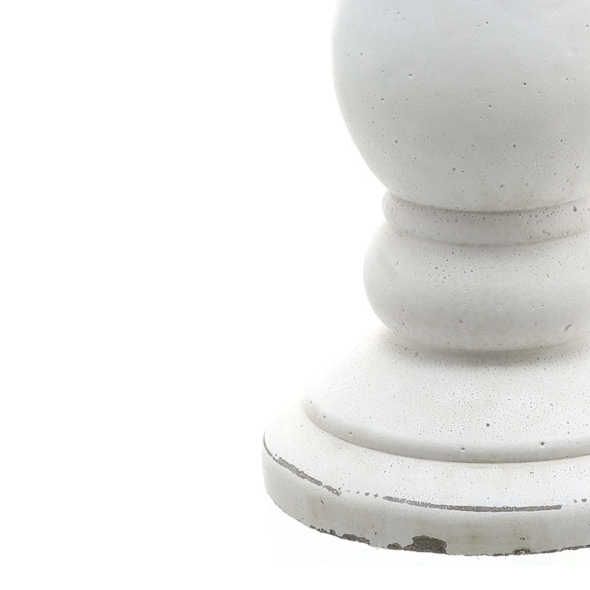Close-up of the candle holder's lower rounded section and stepped foot, showing fine pits in the white surface and grey marks around the base.