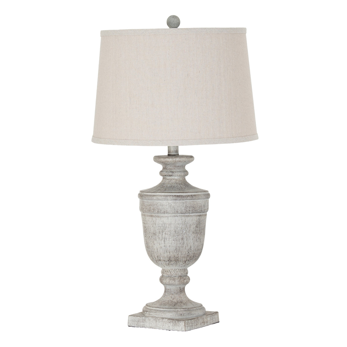 White-grey urn-shaped table lamp on a square plinth, with a pale tapered shade and small ball finial.