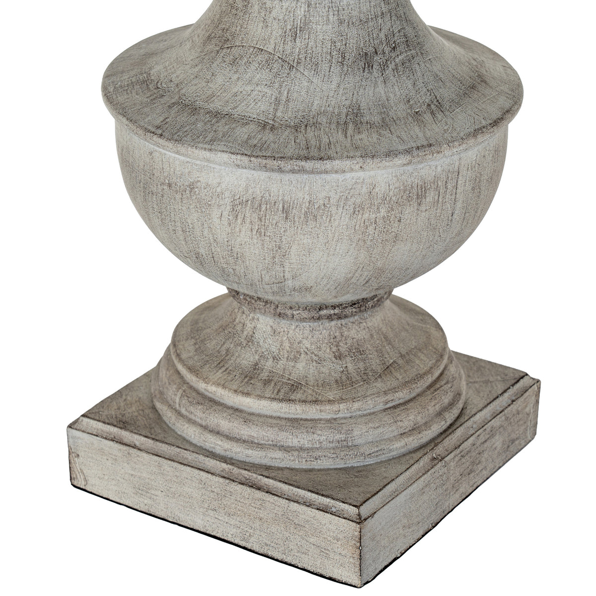 Close-up of the lamp's rounded urn body, stepped foot and square plinth, showing darker markings through the white-grey washed finish.