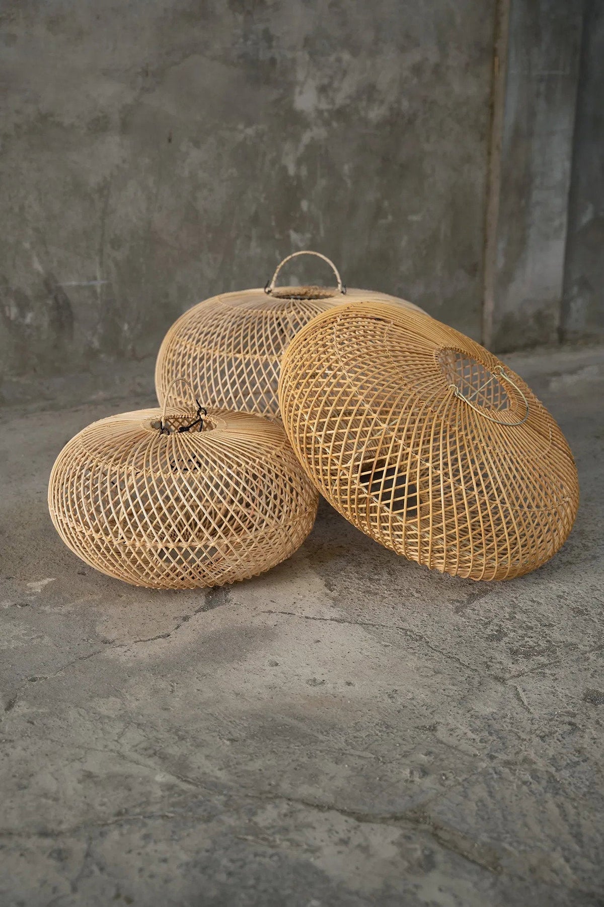 Wholly Rattan Pendant Light – Natural, Large – small medium and large family view on a concrete floor