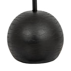 Close view of the rounded black lamp base, showing wavy grain-like bands and fine surface texture around the pole.