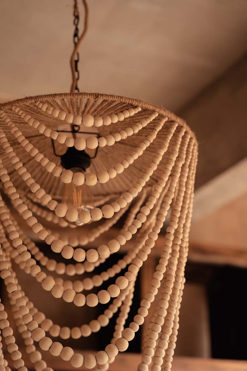 Wooden Bead Chandelier – Natural, Large – underside view in a warm interior
