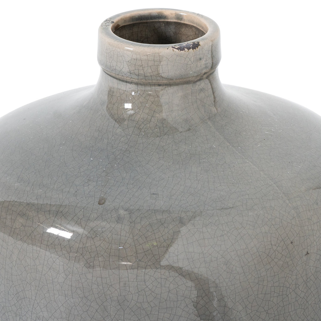 Close-up of the vase opening and rolled rim, with fine crackle lines, a dark patch along the edge and glossy reflections across the grey shoulders.