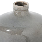 Close-up of the vase opening and rolled rim, with fine crackle lines, a dark patch along the edge and glossy reflections across the grey shoulders.
