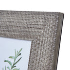 Close-up of the photo frame's upper right corner, showing pale highlights across the woven-look pattern and its plain side edge.