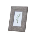 Angled front view of a grey-brown photo frame with a broad woven-texture border and a green botanical illustration in the opening.
