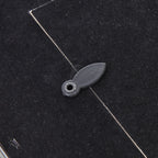 Detail of an oval turn tab overlapping the edge of the photo frame's dark rear panel.