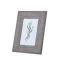 Angled front view of a grey photo frame with a wide woven-texture border around a green botanical insert.