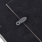 Detail of an oval turn tab crossing the edge of the dark rear panel.