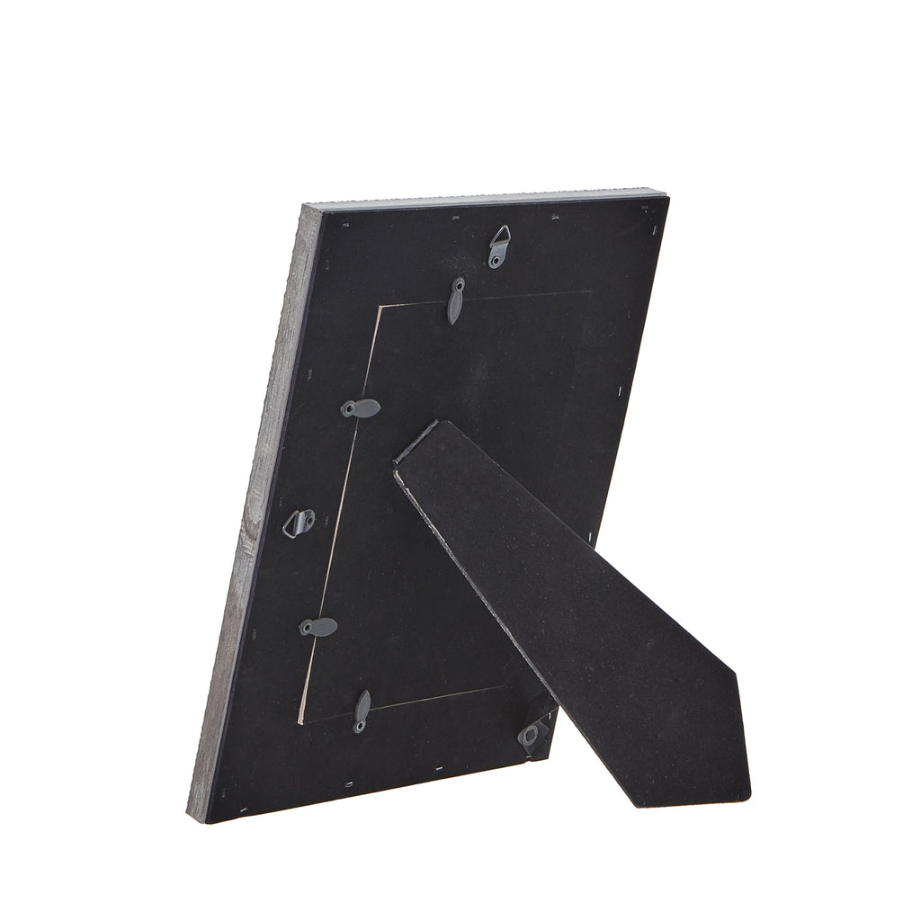 Rear view of the photo frame with its dark panel, turn tabs and extended easel stand.