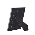Rear view of the photo frame with its dark panel, turn tabs and extended easel stand.