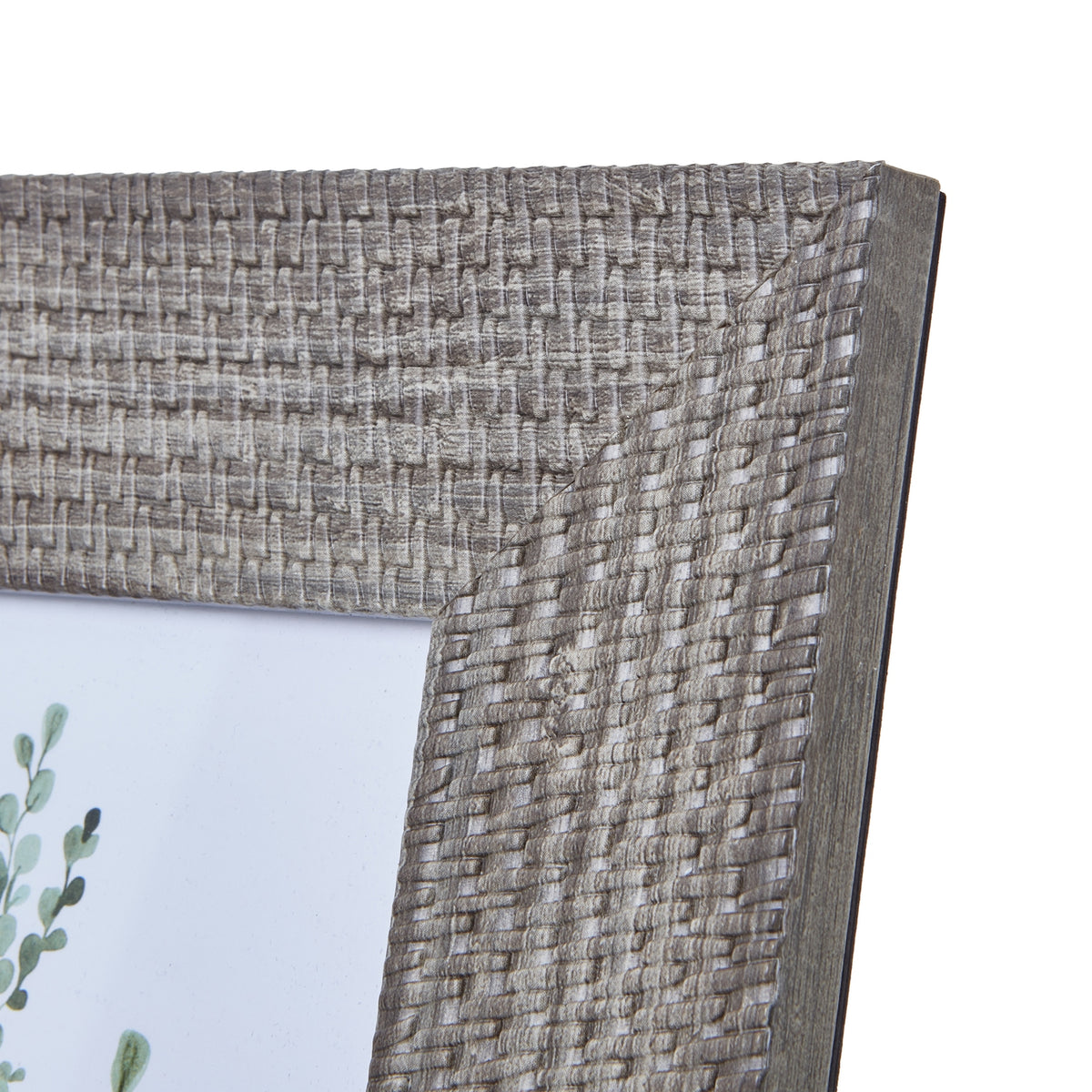 Close-up of the frame's upper right corner, showing the basketweave-like relief, pale highlights and darker side edge.