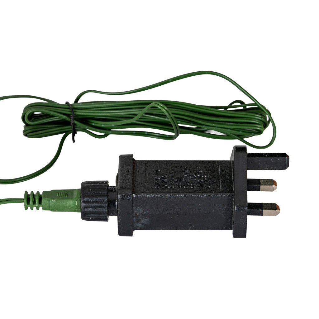 Black three-pin plug and rectangular transformer pictured with a green connector and coiled green cable held by a black tie.