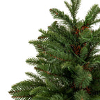 Detail of the artificial tree's upper branches, with mixed green needle textures, brown accents and small clear lamps against a white background.