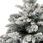 Close-up of dense green artificial fir branches coated with thick, granular white flocking.