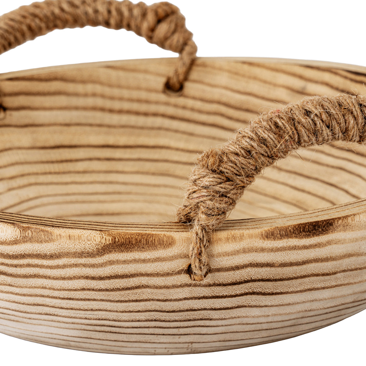 Close-up of a tan fibrous loop handle and its attachment at the bowl's rim, with dark grain running across the pale interior and outer wall.