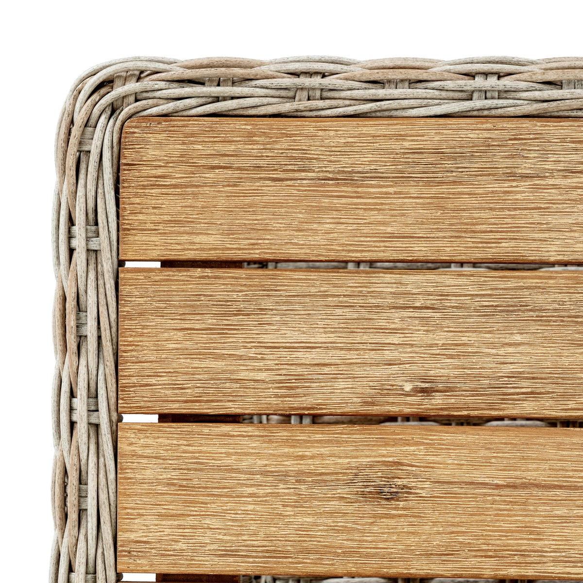 Top corner of the coffee table showing brown slats with pale streaks and a curved woven border.
