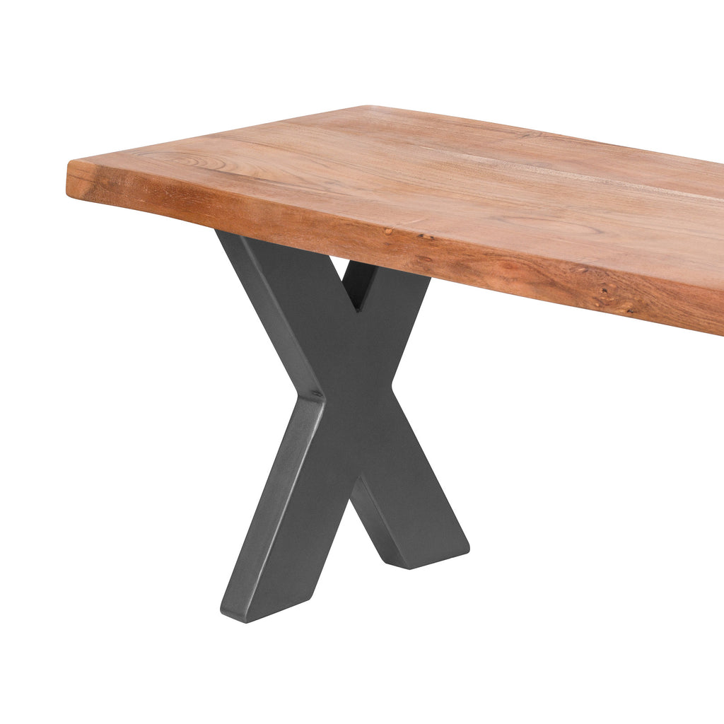 Detail of a grey X-shaped bench leg beneath the warm-brown seat, with the uneven front edge and darker knots visible.